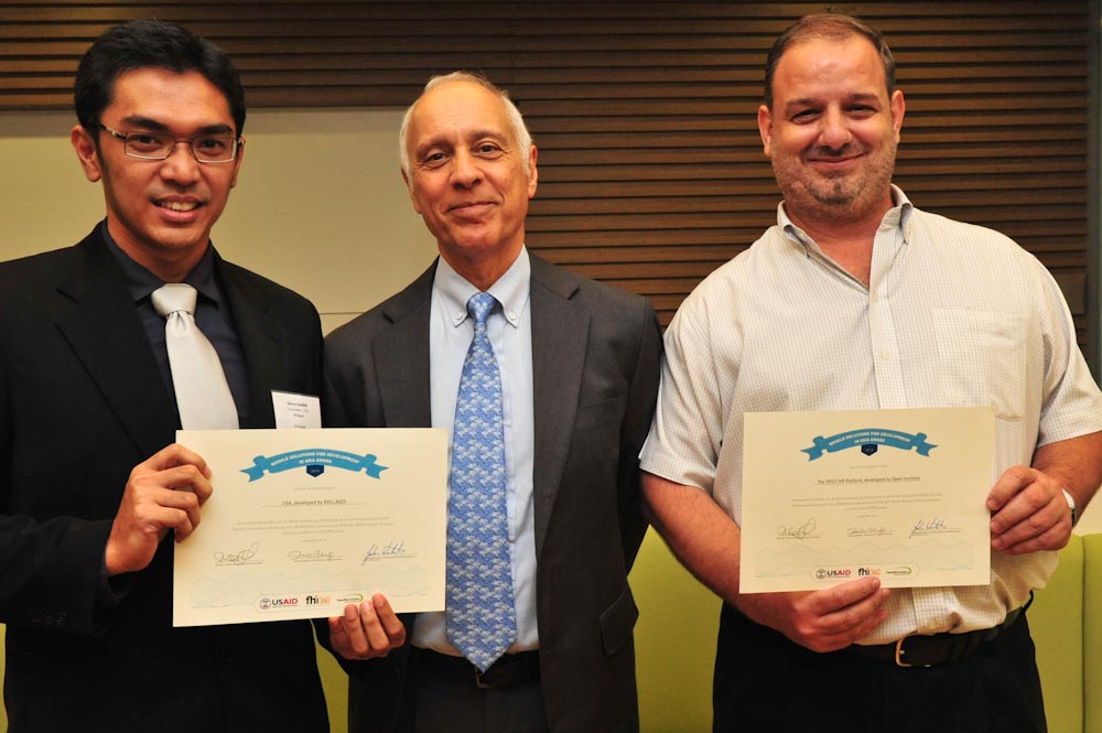USAID RDMA Director Michael Yates (center) with Mobile Solutions M4D Contest Award Winners Javier Sola of the Open Institute, first place (right)